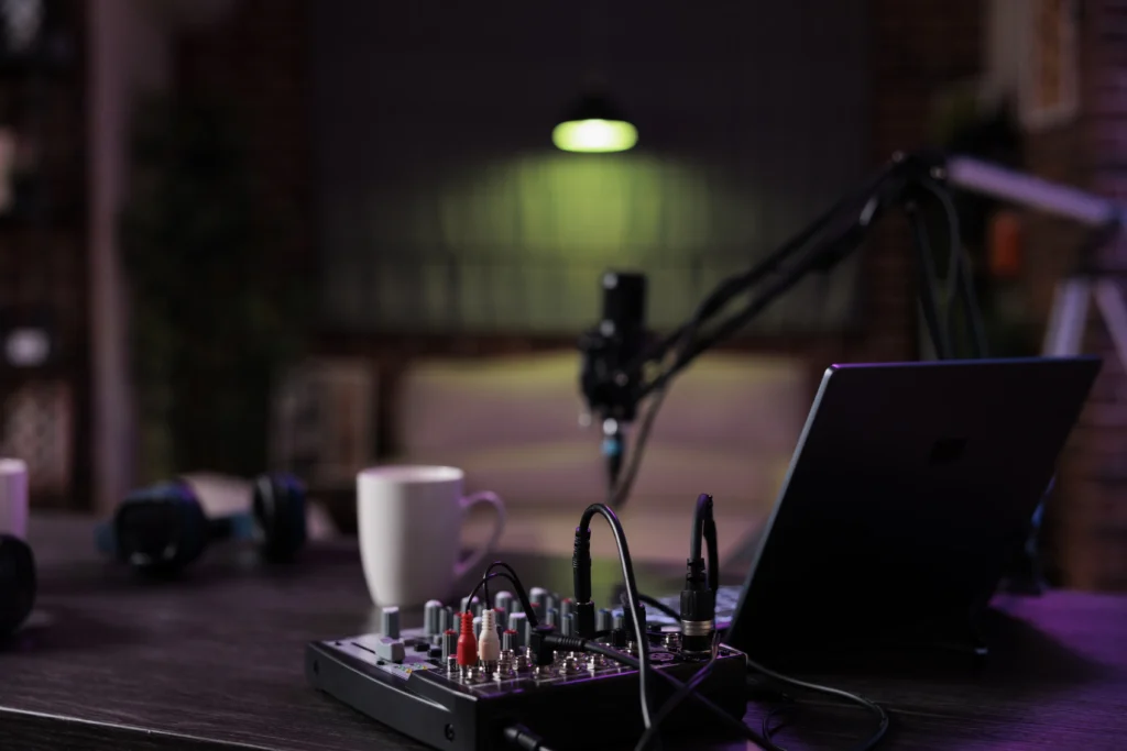 empty desk with podcast equipment record live talking show home no people living room used online vlogging broadcasting conversation with microphone sound production